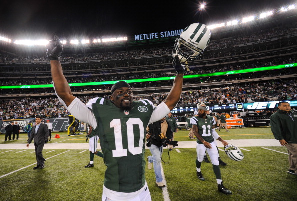 EAST RUTHERFORD, NJ - SEPTEMBER 22: Wide receiver Santonio Holmes #10 of the New York Jets celebrates at the end of the Jets 27-20 win over the Buffalo Bills at MetLife Stadium on September 22, 2013 in East Rutherford, New Jersey. (Photo by Ron Antonelli/Getty Images)