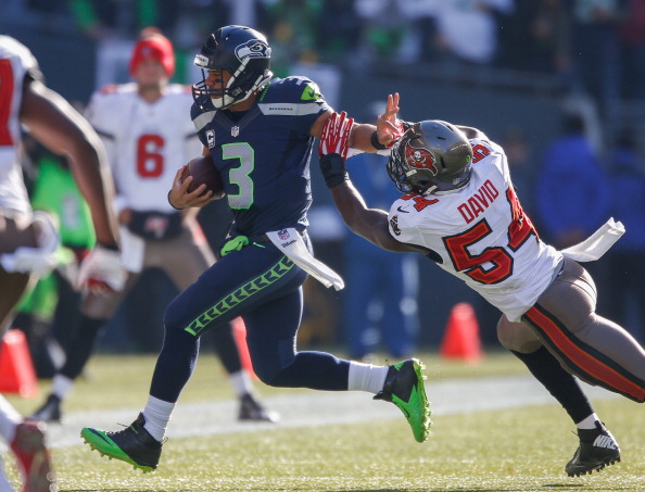SEATTLE, WA - NOVEMBER 03:  Quarterback Russell Wilson #3 of the Seattle Seahawks rushes against Lavonte David #54 of the Tampa Bay Buccaneers at CenturyLink Field on November 3, 2013 in Seattle, Washington. The Seahawks defeated the Buccaneers 27-24 in overtime.  (Photo by Otto Greule Jr/Getty Images)
