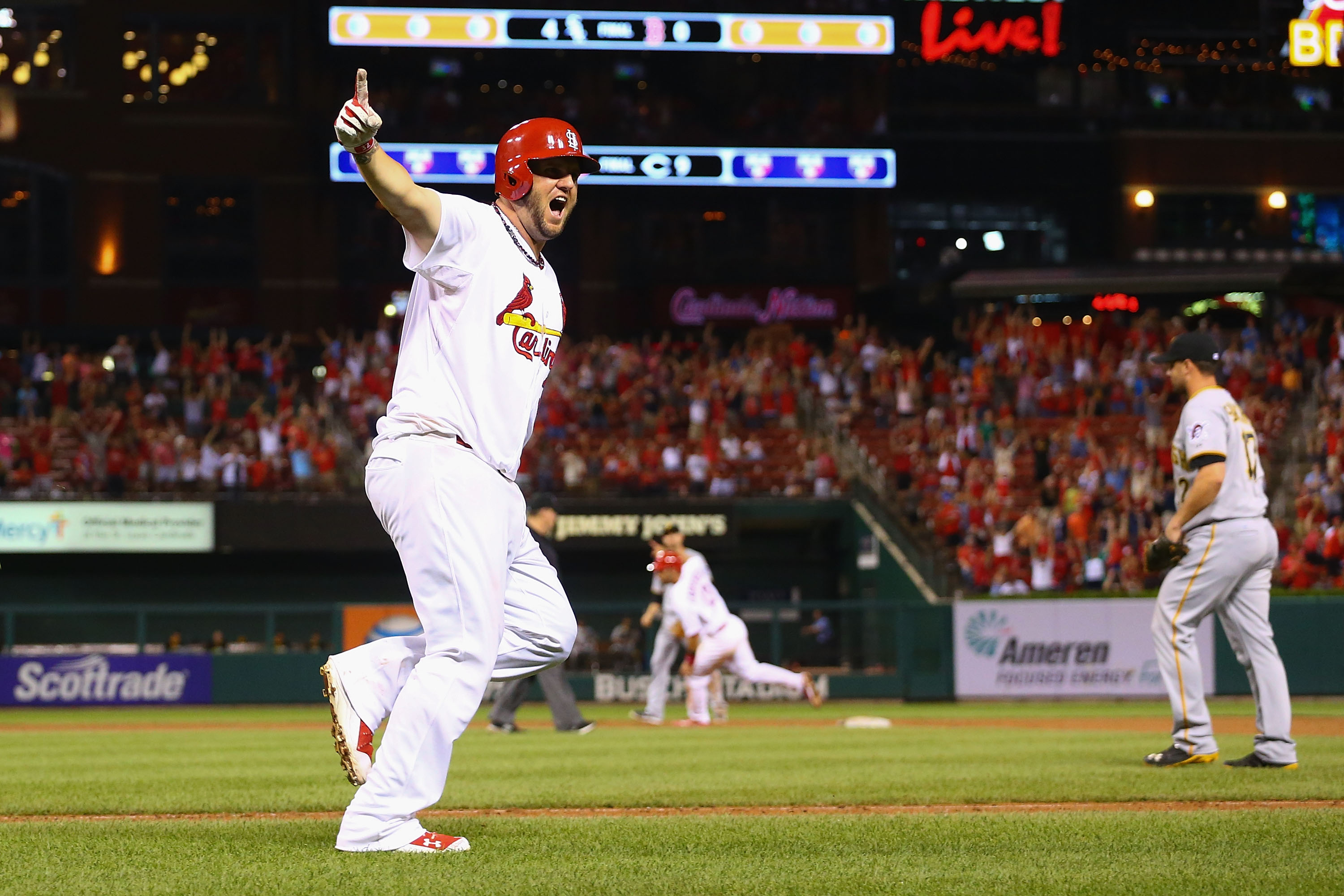 ST. LOUIS, MO - JULY 7: Matt Adams #32 of the St. Louis Cardinals celebrates after hitting a two-run walk-off home run against the Pittsburgh Pirates in the ninth inning at Busch Stadium on July 7, 2014 in St. Louis, Missouri.  The Cardinals beat the Pirates 2-0 with a walk-off home run.