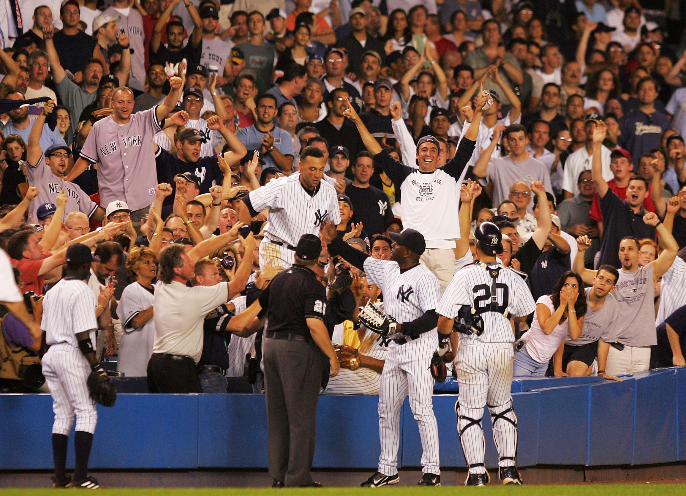 Derek Jeter is helped back on the field after making a diving catch into the crowd in the 12th inning against the Boston Red Sox on July 1, 2004 at Yankee Stadium. The Yankees won 5-4 in 13 innings.  (Photo by Ezra Shaw/Getty Images)