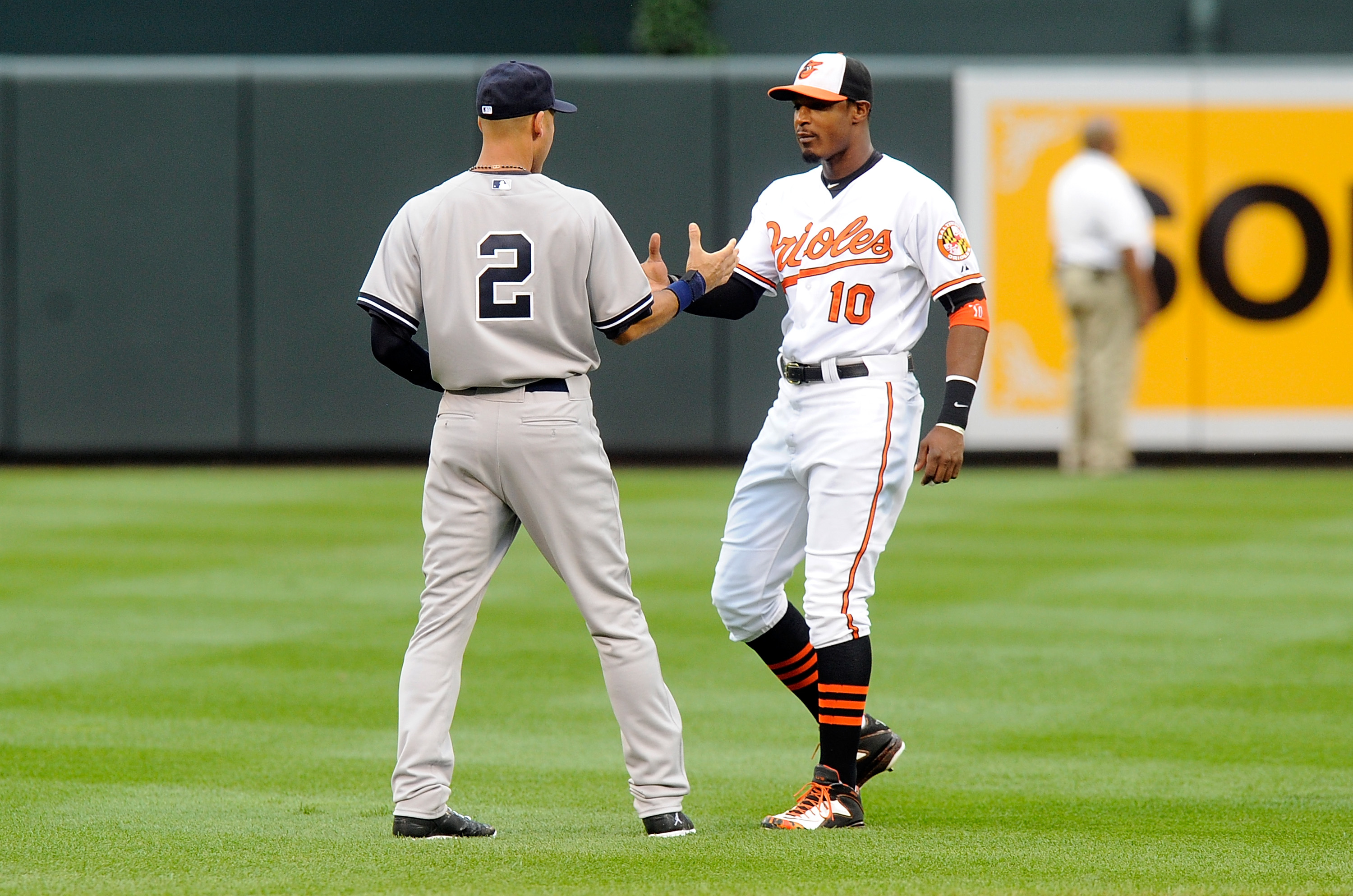Derek Jeter greets Adam Jones in Baltimore on August 11, 2014.  (Photo by Greg Fiume/Getty Images)