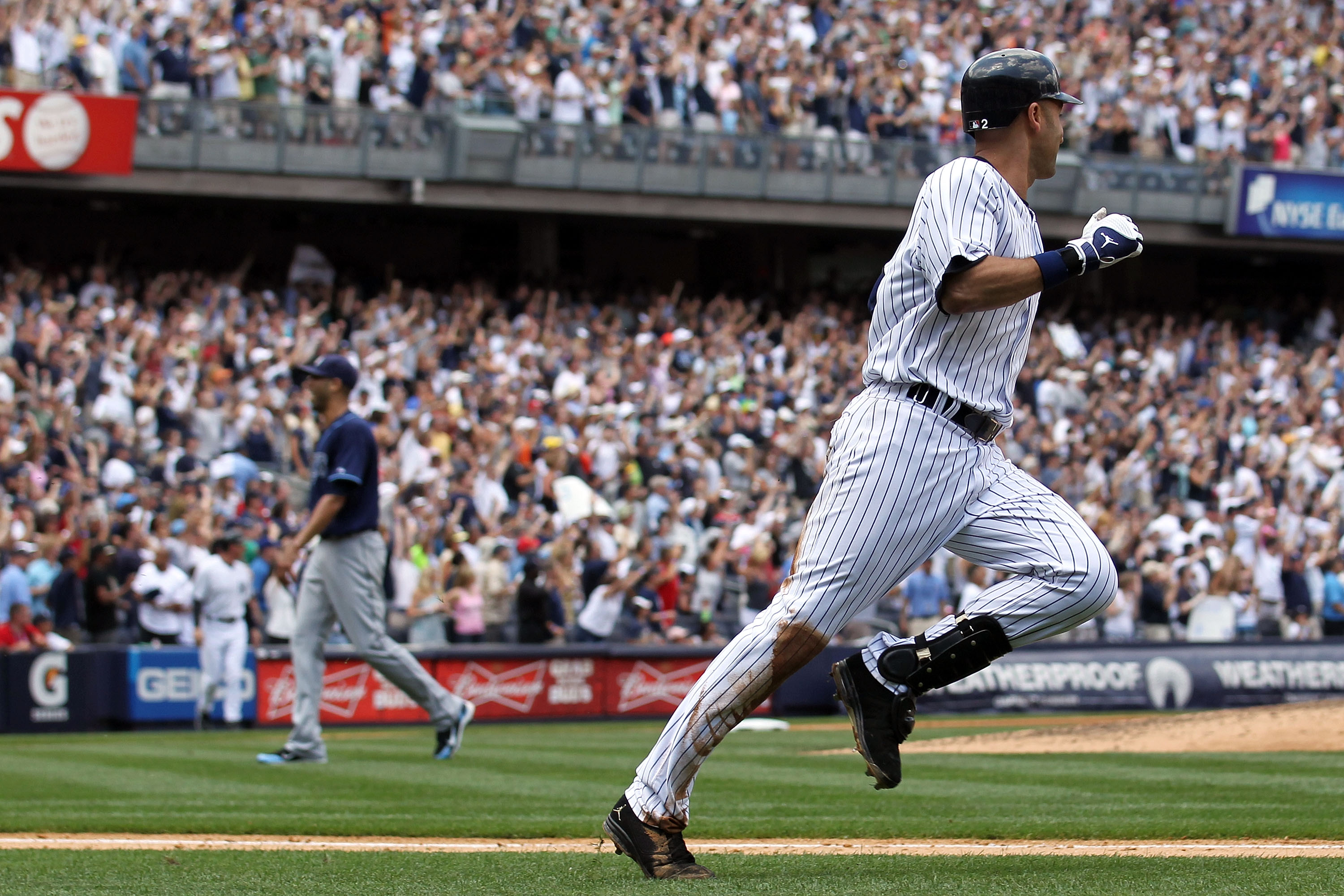 Derek Jeter rounds the bases after hitting a solo home run in the third inning off David Price for career hit No. 3,000.  (Photo by Nick Laham/Getty Images)
