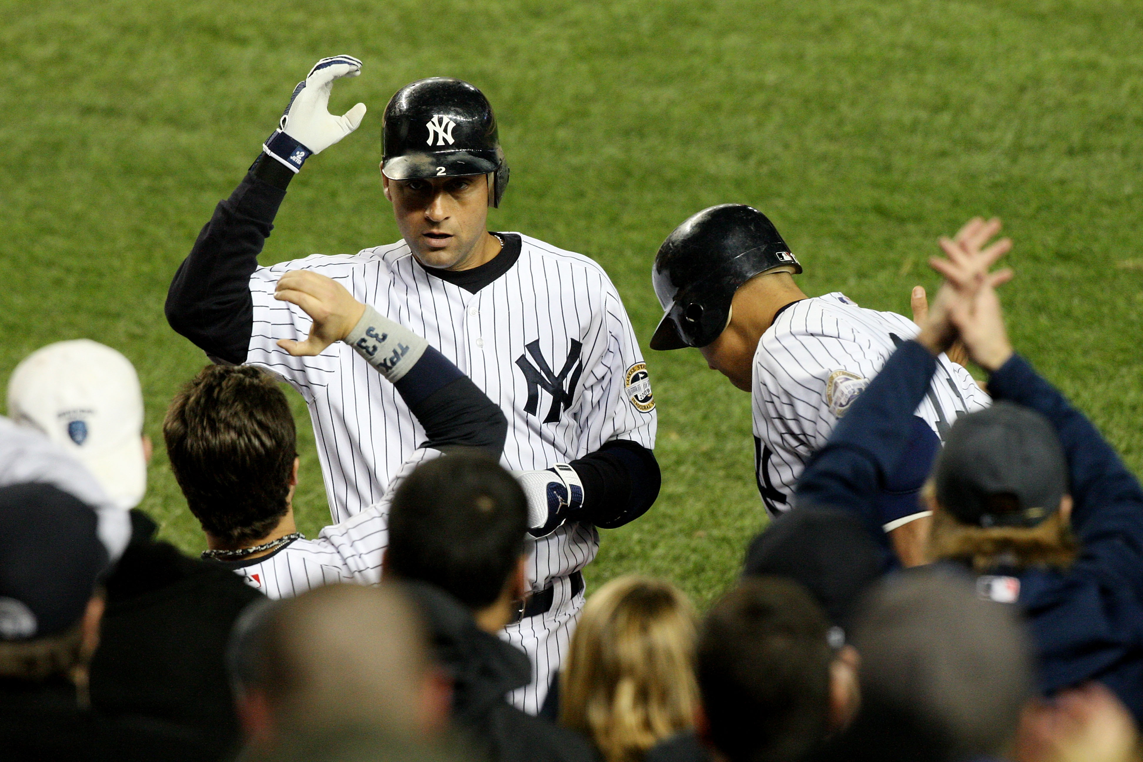 Derek Jeter is congratulated by Nick Swisher after hitting a solo home run in the bottom of the third inning against the Los Angeles Angels in Game 2 of the 2009 ALCS.  (Photo by Jim McIsaac/Getty Images)