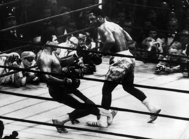 Muhammad Ali goes down in the 15th round to a left hook from world heavyweight champion Joe Frazier.