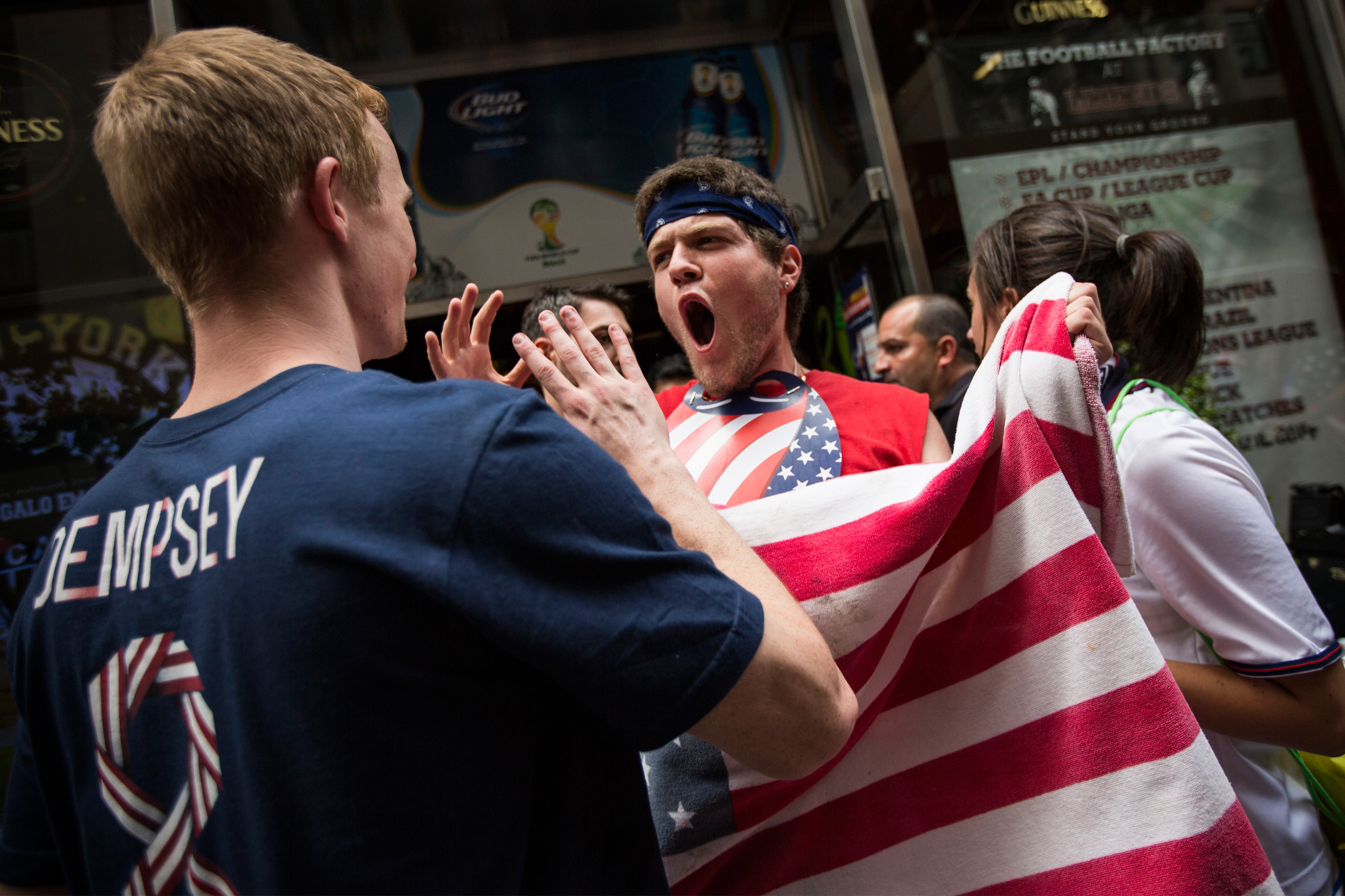 Fans of the United States Men's National Team celebrate while leaving a bar after the Americans advanced to the knockout round of the World Cup on June 26, 2014 in New York City. (Photo by Andrew Burton/Getty Images)