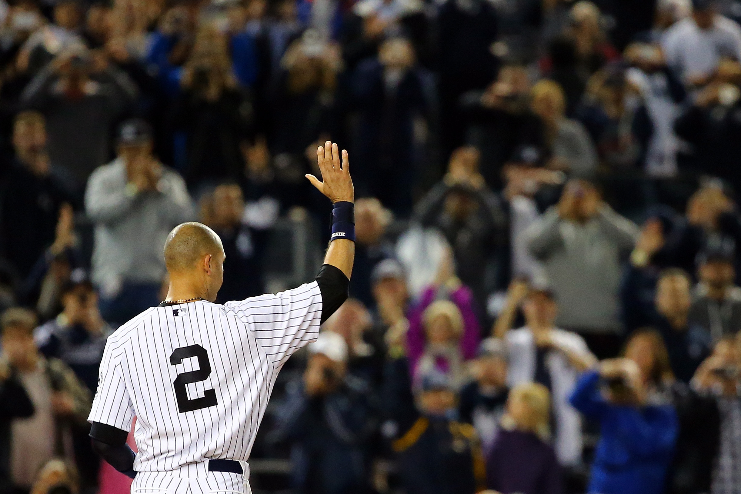 Derek Jeter gestures to the fans after a game-winning RBI hit in the ninth inning against the Baltimore Orioles in his last game ever at Yankee Stadium on September 25, 2014.  (Photo by Al Bello/Getty Images)