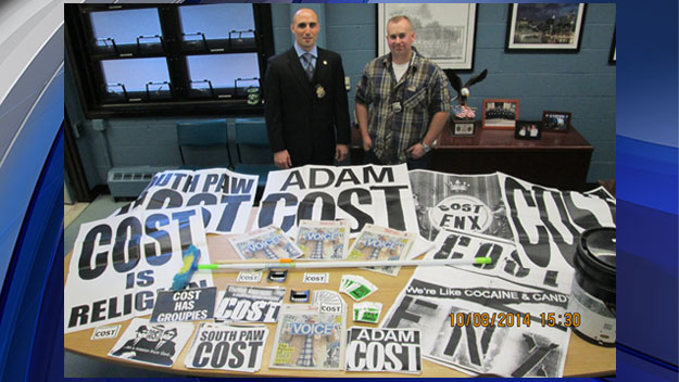 NYPD Sgt. Michael Alfieri and Officer Colin Sullivan pose before work by graffiti by artist Adam Cole, better known as Adam Cost. (Credit: NYPD)