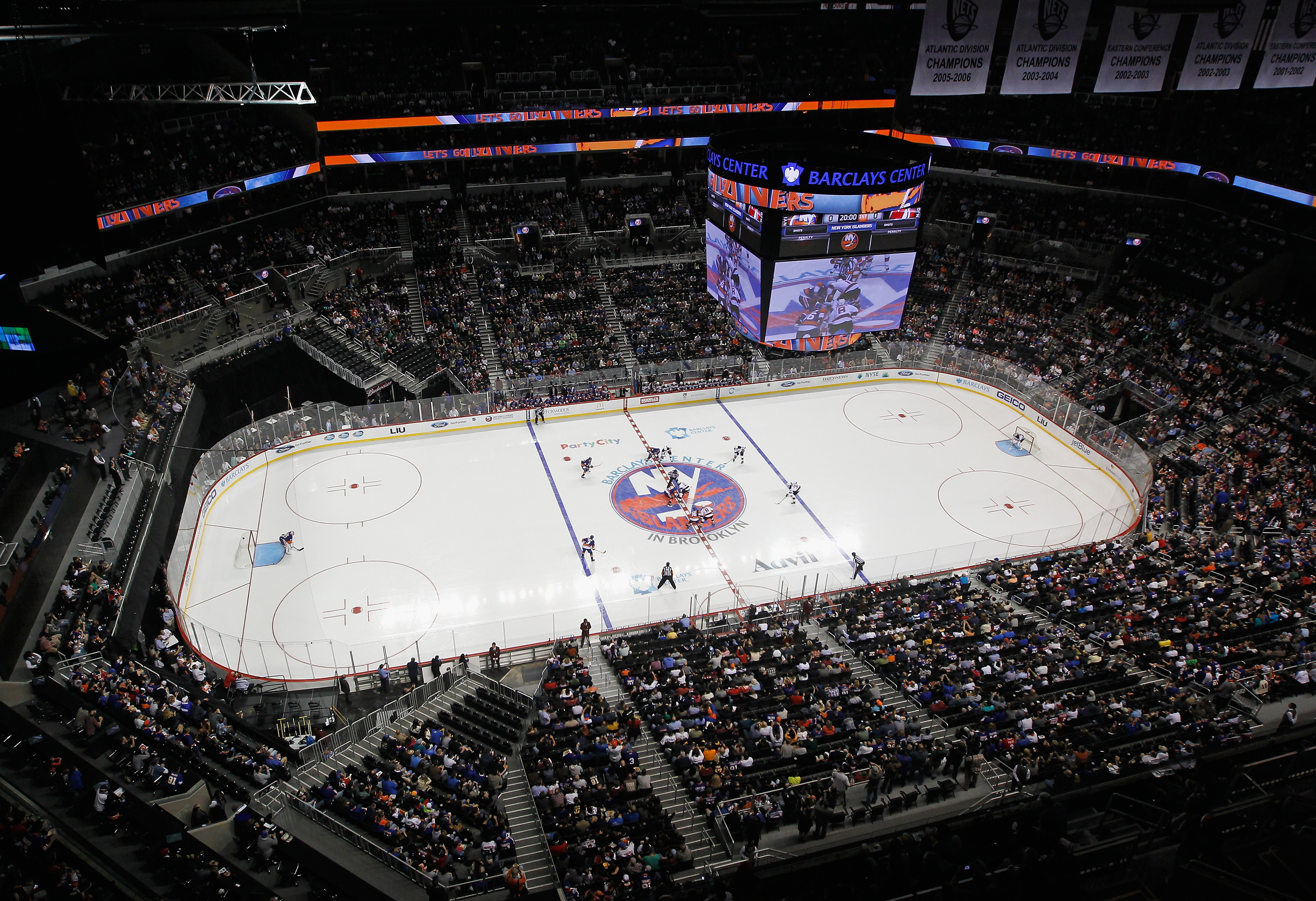 The New York Islanders and New Jersey Devils drop the opening puck during a preseason game at Barclays Center. (Photo by Bruce Bennett/Getty Images)