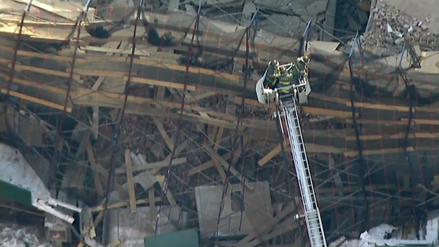 Emergency responders on the scene of a collapse on West 57th street on Feb. 25, 2015. (credit: CBS2) 