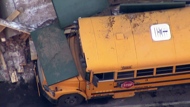 Debris atop a parked school bus following a partial collapse on West 57th street on Feb. 25, 2015. (credit: CBS2) 