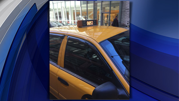 A man believes he was the victim of a credit card skimmer in this allegedly fake cab. He notes the medallion light had only three numbers. (Credit: CBS2)