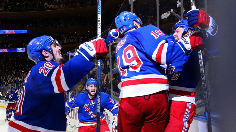 Derek Stepan celebrates with Chris Kreider #20, Jesper Fast #19 and the rest of the New York Rangers after scoring the game-winning goal in overtime against the Washington Capitals to win Game 7 of the Eastern Conference semifinals 2-1 at Madison Square Garden on May 13, 2015. (Photo by Bruce Bennett/Getty Images)