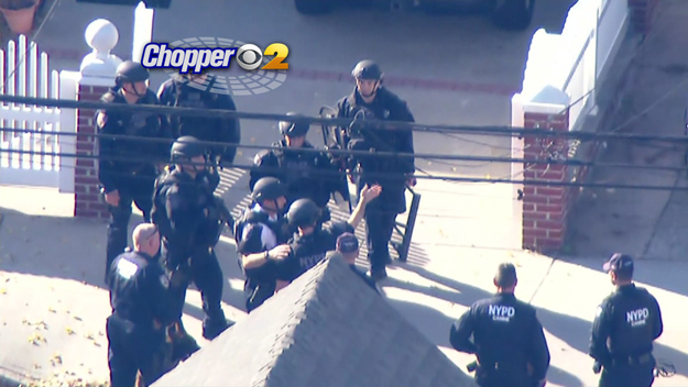 NYPD officers search for a suspect after a struggle for a DEA agent's gun in Queens on Nov. 3, 2015. (credit: CBS2) 