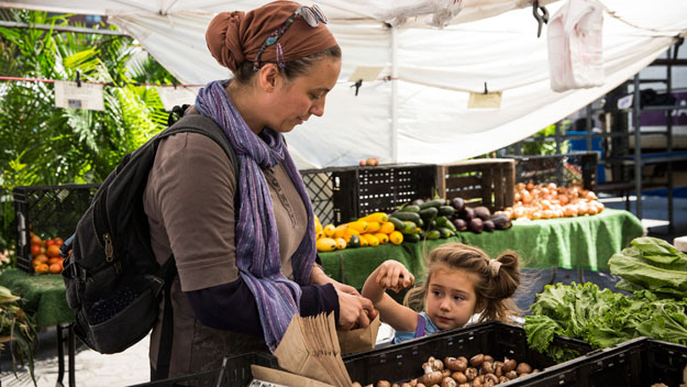 A woman and her daughter shops for groceries in the GrowNYC Greenmarket in Union Square (Photo by Andrew Burton/Getty Images)